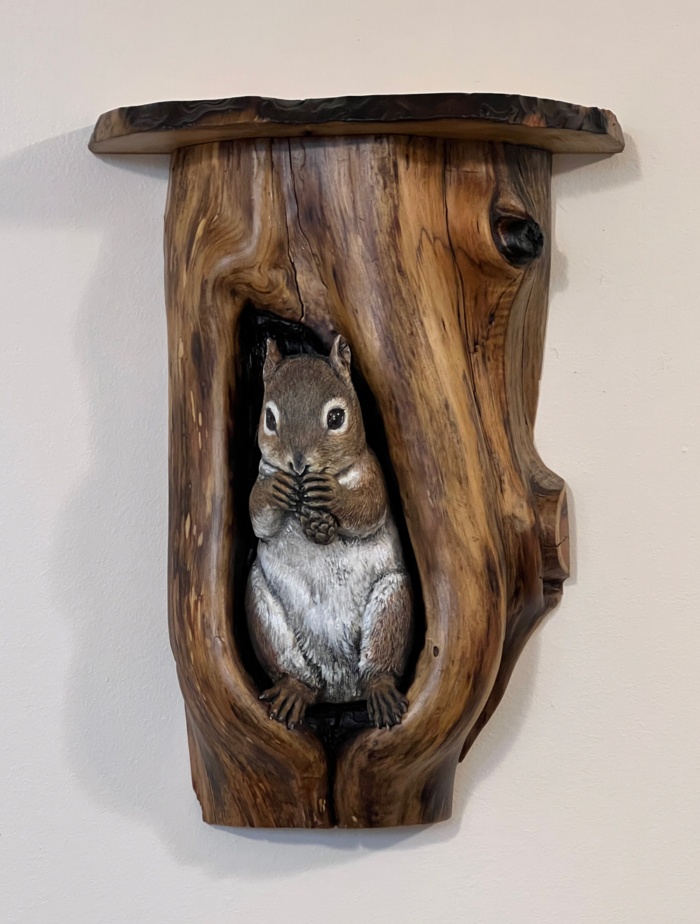 red squirrel sits in juniper den hanging mini shelf